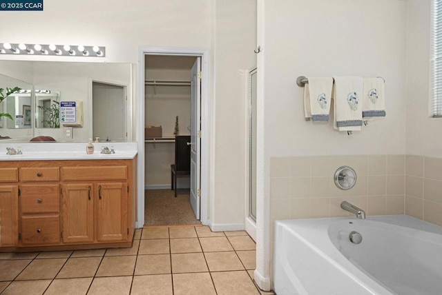 bathroom featuring separate shower and tub, tile patterned flooring, and vanity