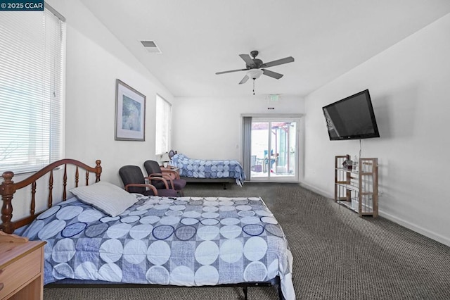 bedroom featuring ceiling fan, dark carpet, and multiple windows