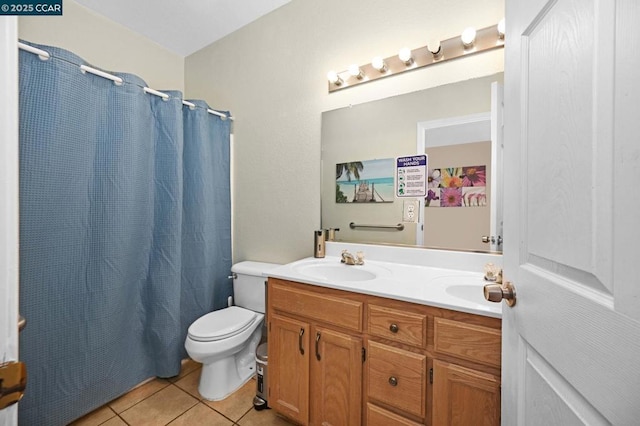 bathroom with vanity, toilet, tile patterned floors, and curtained shower