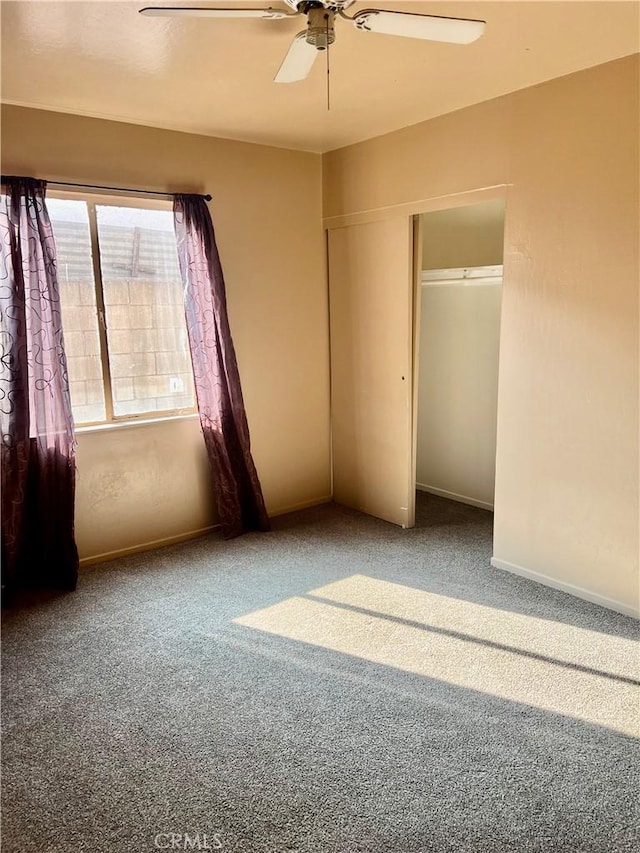 unfurnished bedroom featuring a closet, ceiling fan, and carpet