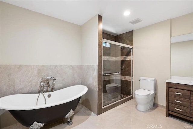 full bathroom featuring toilet, tile walls, vanity, independent shower and bath, and tile patterned flooring