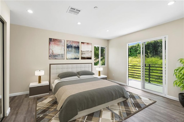 bedroom with wood-type flooring and access to outside