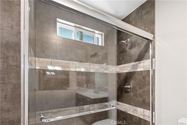 bathroom with a shower with door