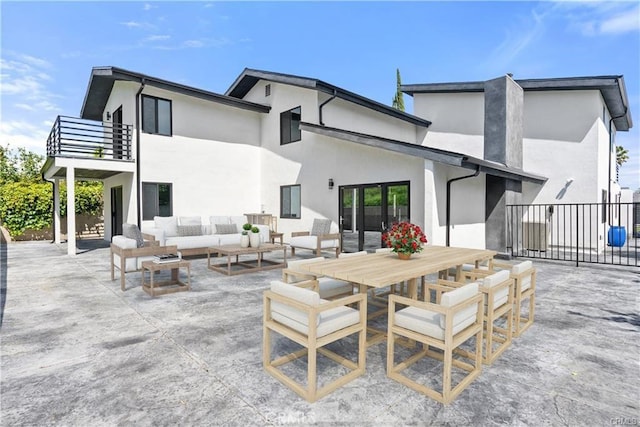 back of house with a patio, a balcony, and an outdoor hangout area