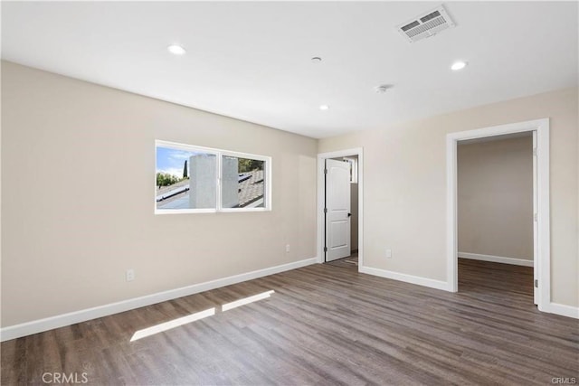 empty room with dark wood-type flooring