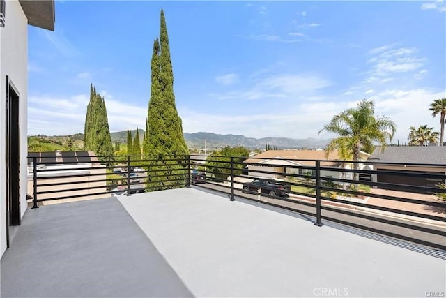 view of patio with a mountain view and a balcony