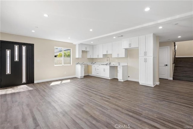 kitchen featuring white cabinetry, dark hardwood / wood-style flooring, and sink