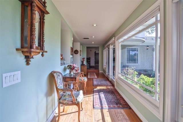 hall featuring hardwood / wood-style floors and a wealth of natural light