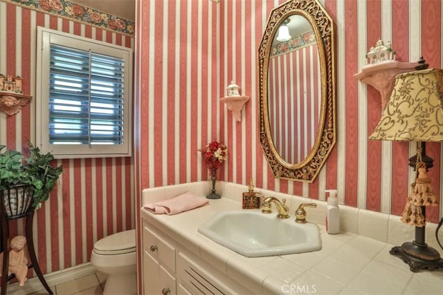 bathroom featuring toilet and vanity