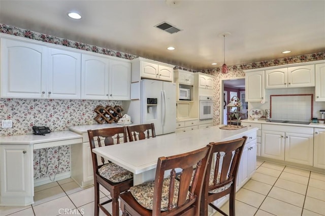 kitchen featuring white cabinetry, white appliances, decorative backsplash, and light tile patterned flooring