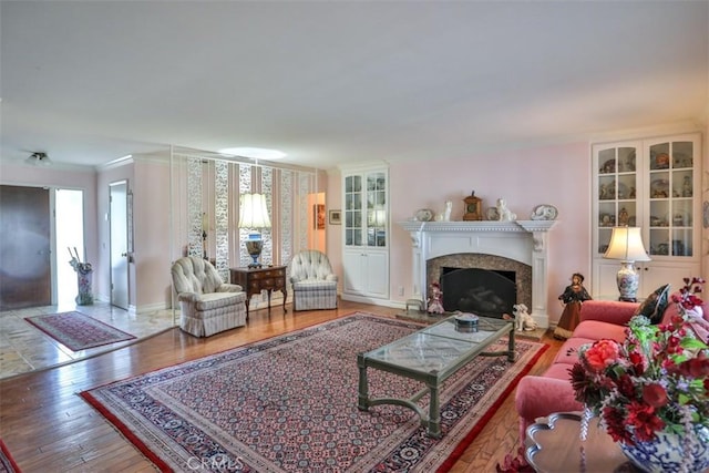 living room with hardwood / wood-style flooring and ornamental molding