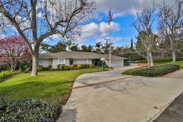 ranch-style house featuring a front yard and a garage