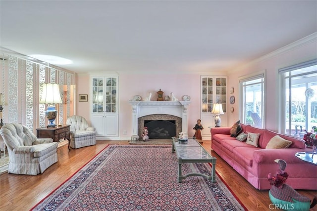 living room with hardwood / wood-style flooring and ornamental molding