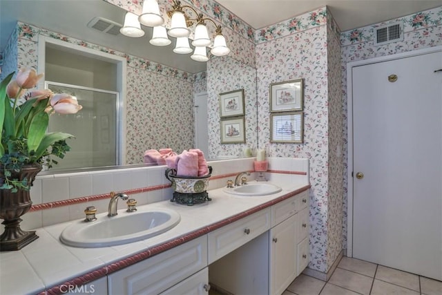 bathroom with a shower with door, tile patterned floors, backsplash, vanity, and a chandelier