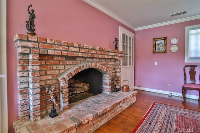 interior space featuring crown molding, a fireplace, and hardwood / wood-style floors