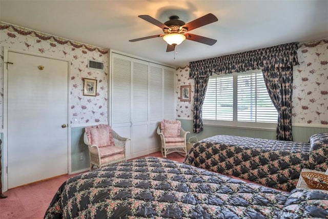 carpeted bedroom with a closet and ceiling fan