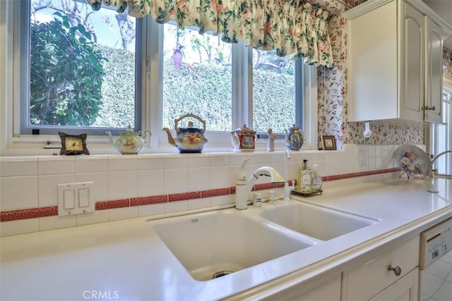 kitchen featuring sink, dishwasher, and a wealth of natural light