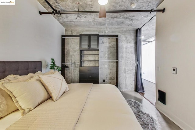 bedroom featuring concrete flooring