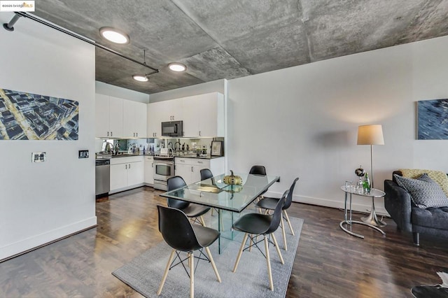 dining space with dark hardwood / wood-style flooring