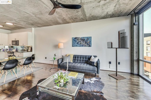 living room with hardwood / wood-style flooring, expansive windows, and ceiling fan