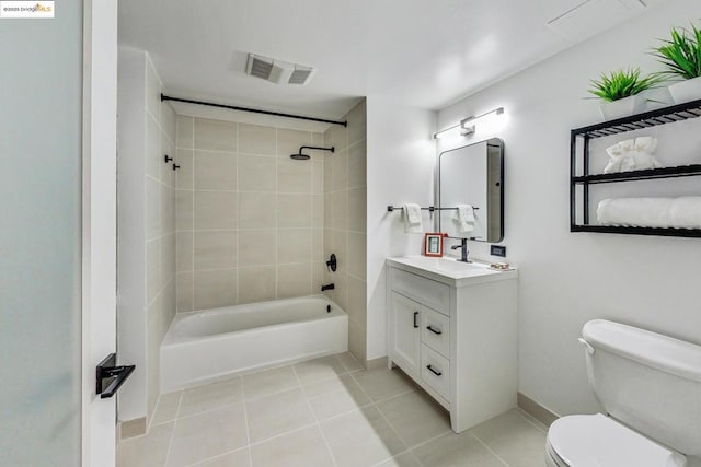 full bathroom featuring toilet, tile patterned flooring, tiled shower / bath, and vanity