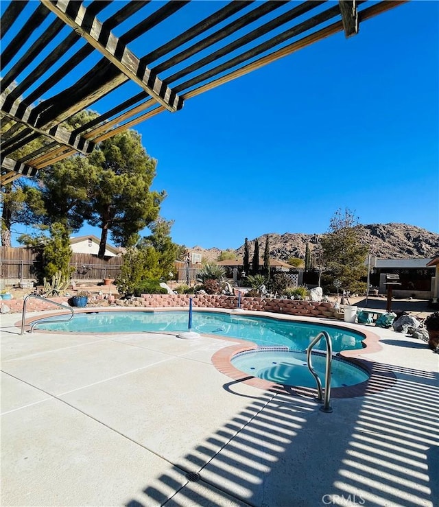 view of swimming pool featuring a mountain view, an in ground hot tub, and a pergola