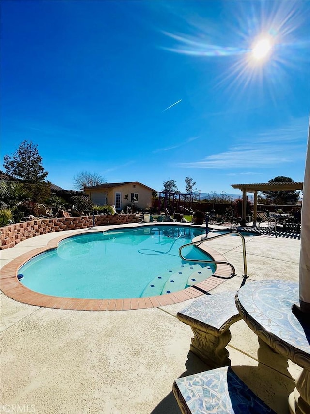 view of pool with a patio area and a pergola