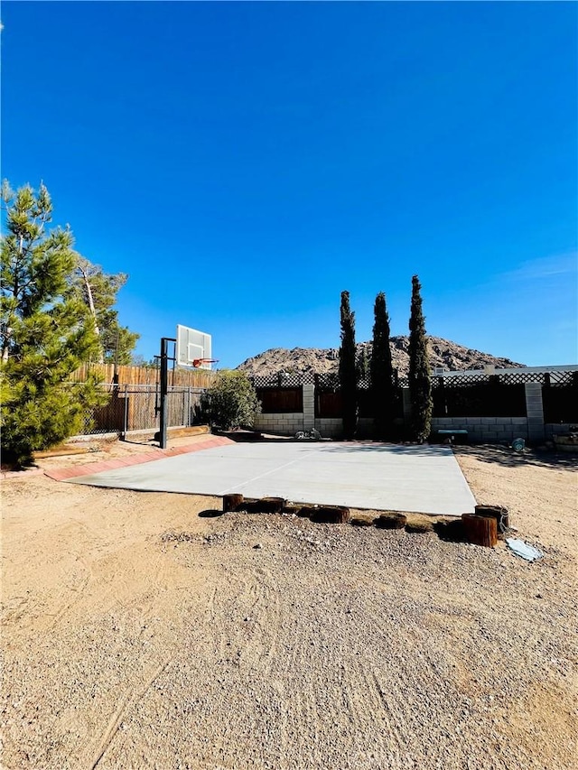 view of yard with basketball hoop