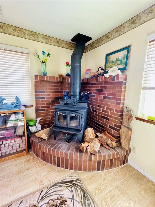 interior details with a wood stove and hardwood / wood-style floors