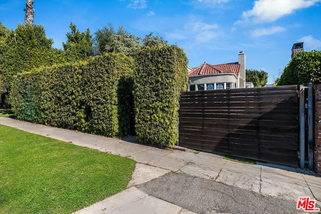 view of gate featuring a yard