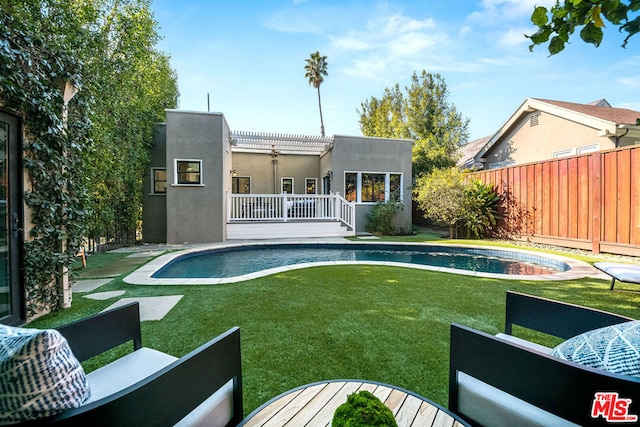 view of pool with a deck, a yard, an outdoor living space, and a pergola