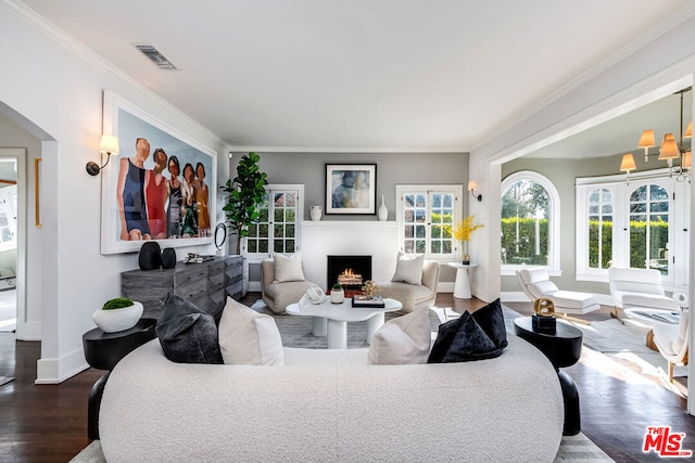 living room with dark wood-type flooring and ornamental molding