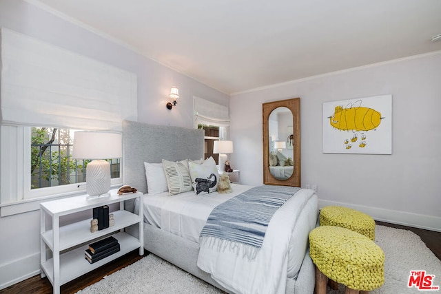 bedroom featuring crown molding and hardwood / wood-style floors