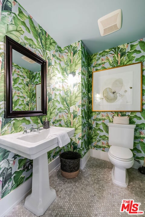 bathroom featuring toilet and tile patterned floors