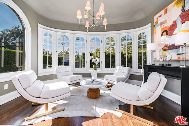 sunroom featuring a chandelier