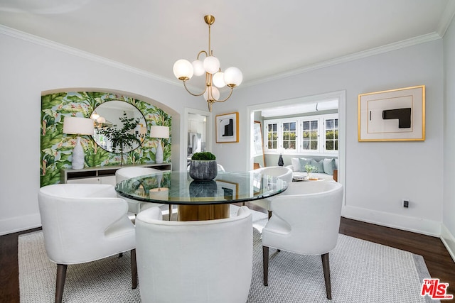 dining space featuring dark hardwood / wood-style flooring, crown molding, and an inviting chandelier