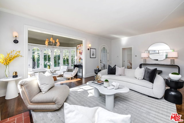 living room with hardwood / wood-style flooring, a chandelier, and ornamental molding