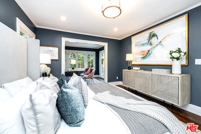 bedroom with ornamental molding and dark hardwood / wood-style flooring