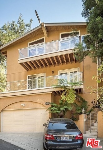 view of front of home featuring a balcony and a garage