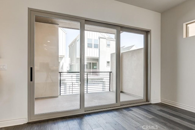 doorway to outside featuring hardwood / wood-style floors and a healthy amount of sunlight