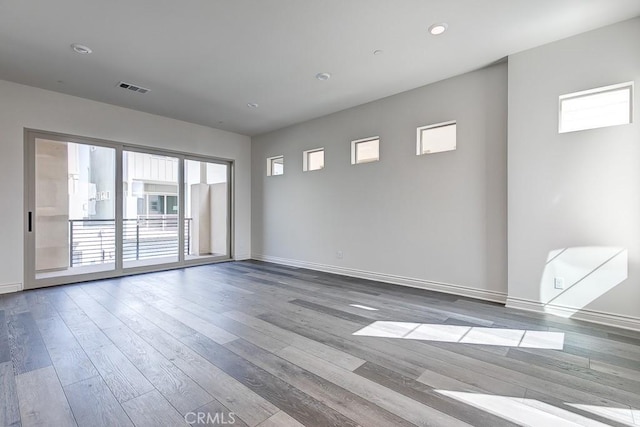 empty room with hardwood / wood-style flooring