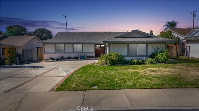 single story home with a front lawn and stucco siding