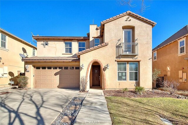 mediterranean / spanish-style home featuring a balcony and a garage