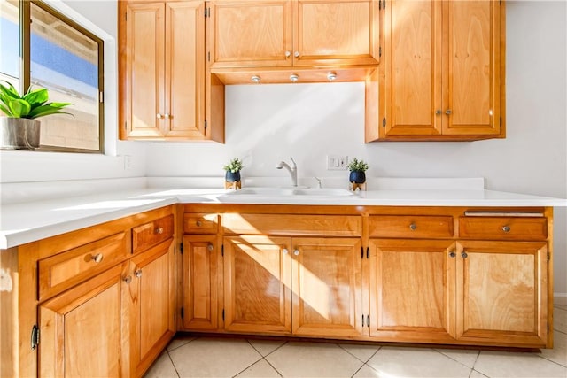 kitchen featuring sink and light tile patterned flooring