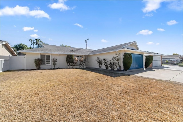 ranch-style home with a garage and a front lawn