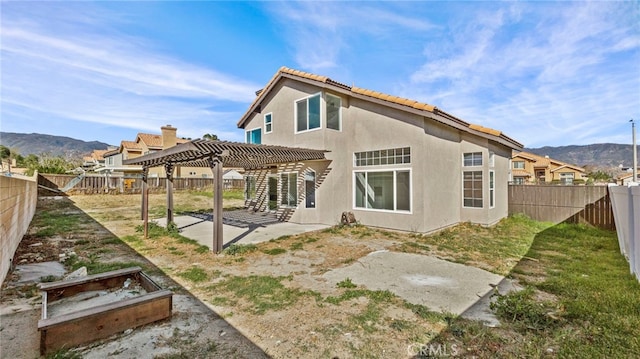 back of house featuring a pergola, a patio area, and a mountain view