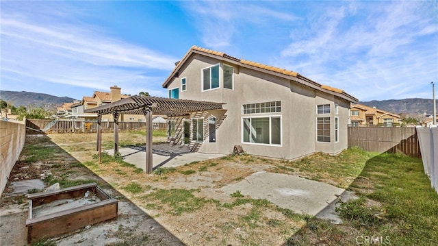 back of house with a patio, a fenced backyard, a tiled roof, a pergola, and stucco siding