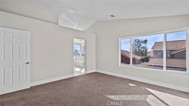 carpeted spare room with lofted ceiling and plenty of natural light