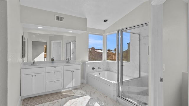 bathroom featuring vanity, vaulted ceiling, and shower with separate bathtub