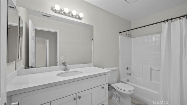 bathroom featuring a textured wall, toilet, vanity, visible vents, and shower / bath combo